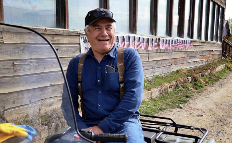 Elder smiling while sitting on his 4-wheeler